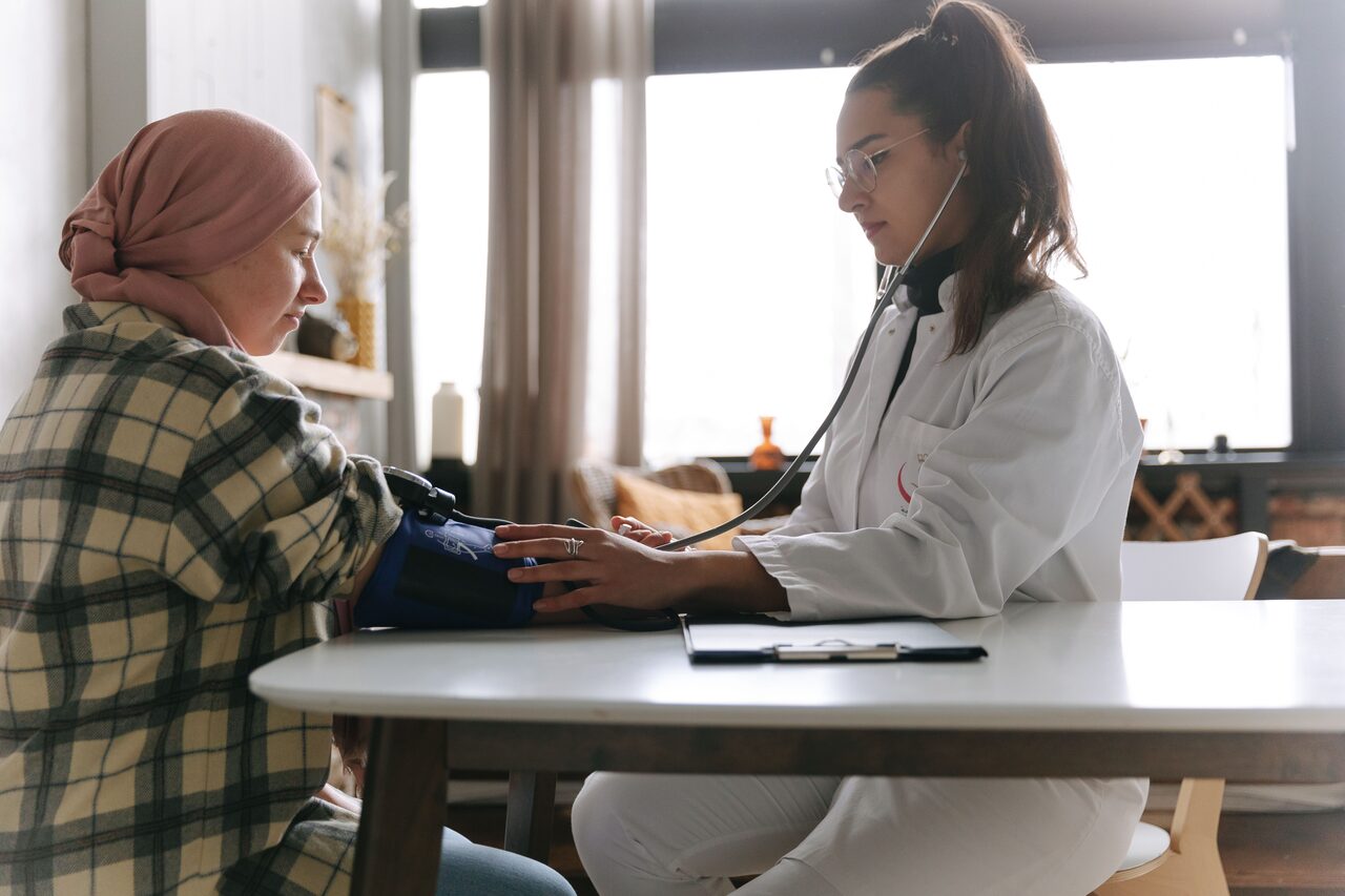 A clinician measuring a patient's blood pressure