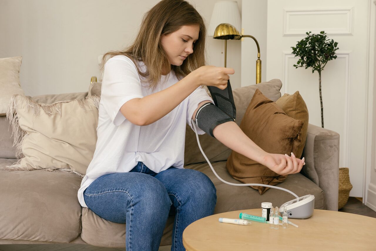A person taking their own blood pressure at home